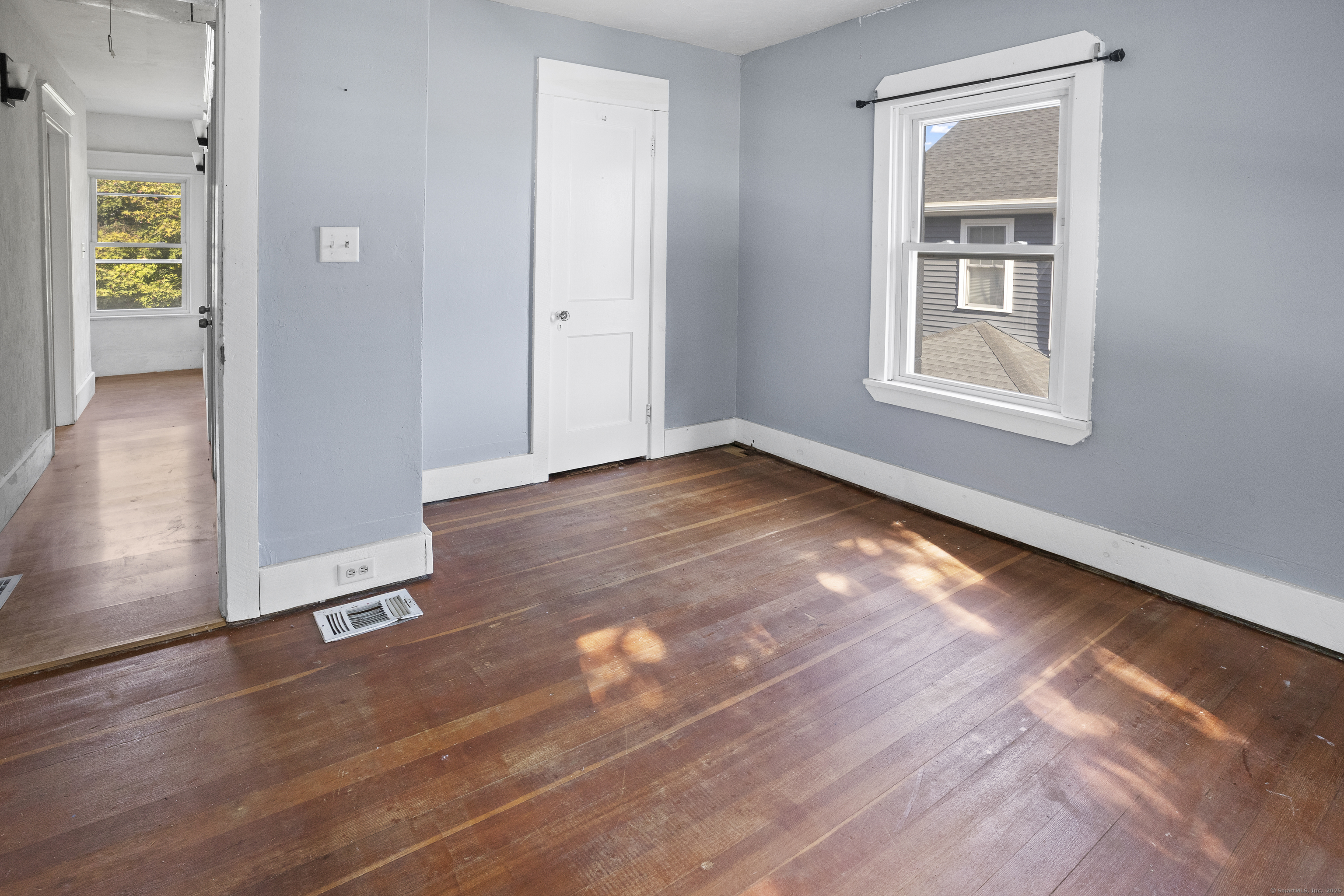 132 Grove Street Putnam, CT 06260 - Photo 34 of 36 a view of an empty room with window and wooden floor