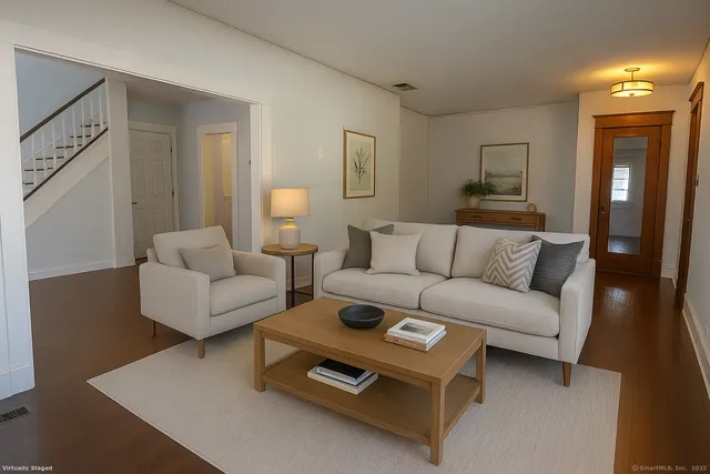 a living room with furniture a couch and wooden floor