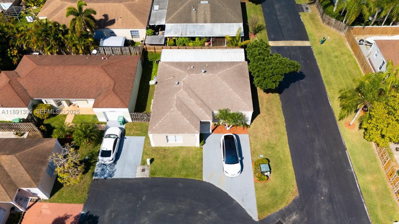an aerial view of a house with a swimming pool