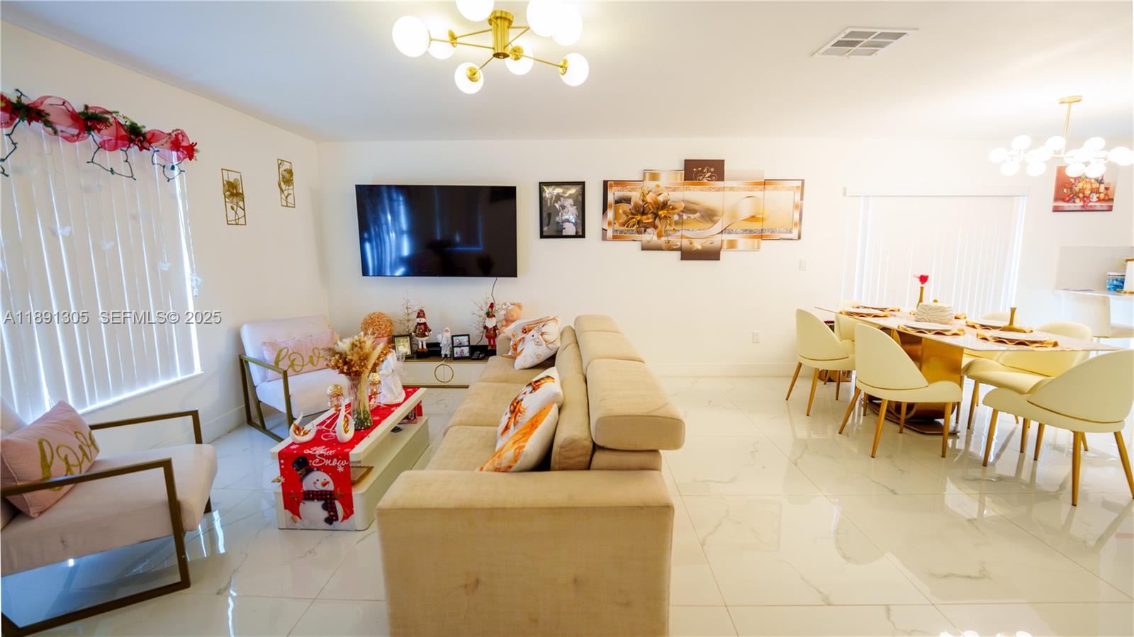 22226 Southwest 98th Place Cutler Bay, FL 33190 - Photo 11 of 29 a living room with furniture and a flat screen tv