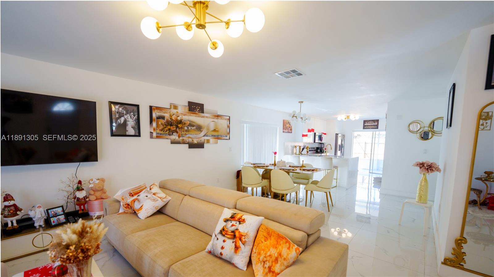 22226 Southwest 98th Place Cutler Bay, FL 33190 - Photo 12 of 29 a living room with furniture and a flat screen tv