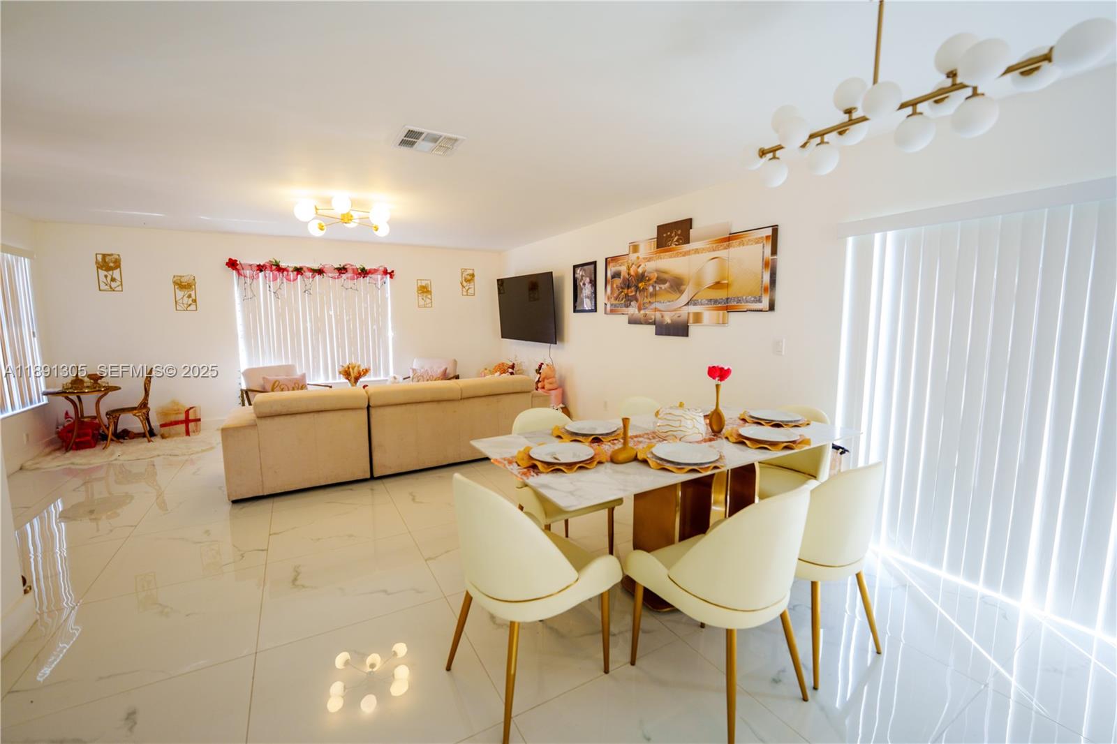 22226 Southwest 98th Place Cutler Bay, FL 33190 - Photo 14 of 29 a living room with furniture and a flat screen tv