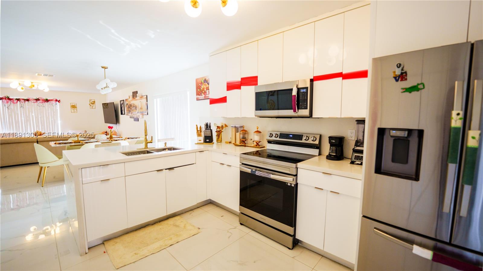 22226 Southwest 98th Place Cutler Bay, FL 33190 - Photo 18 of 29 a kitchen with cabinets and white appliances