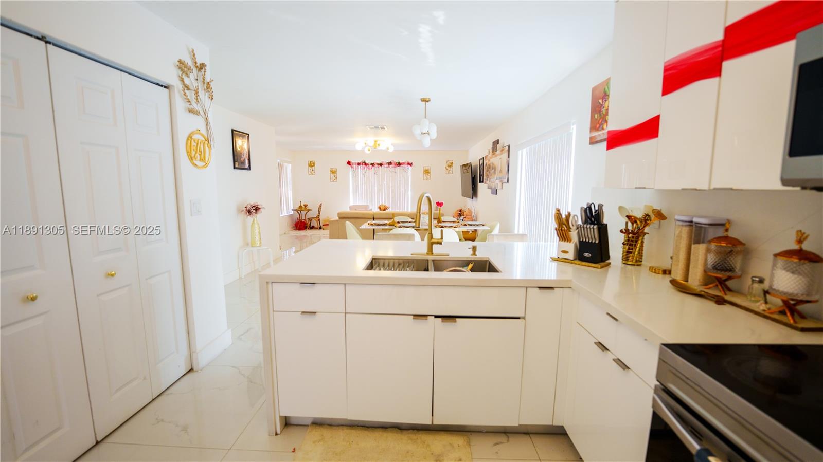 22226 Southwest 98th Place Cutler Bay, FL 33190 - Photo 19 of 29 a kitchen with a sink dishwasher and white cabinets with wooden floor