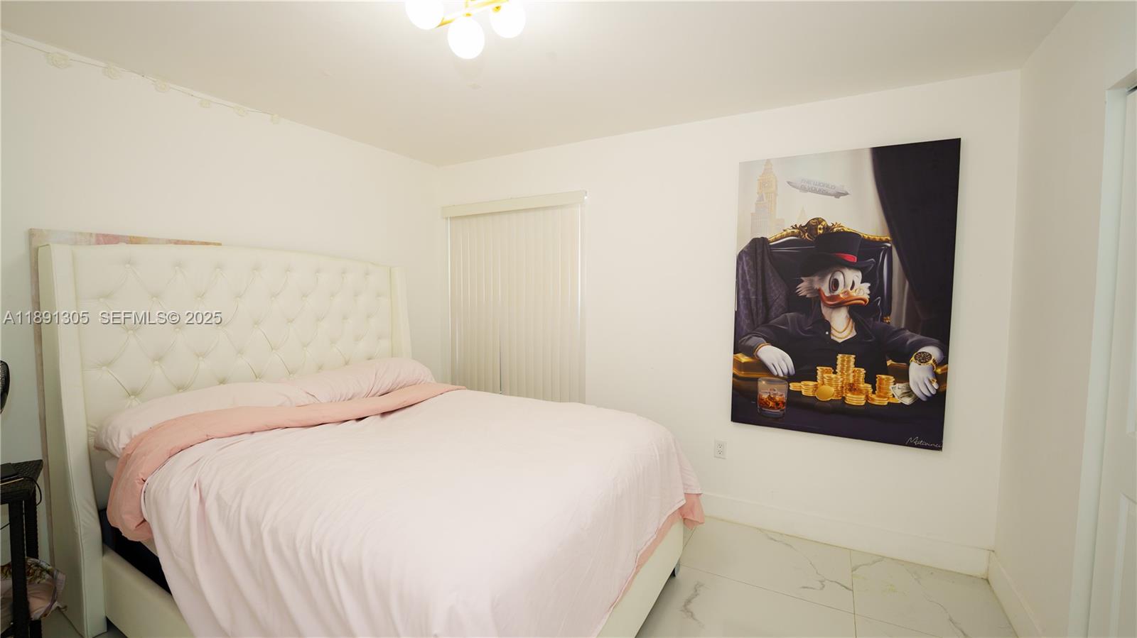 22226 Southwest 98th Place Cutler Bay, FL 33190 - Photo 22 of 29 a bedroom with a bed and a painting on the wall