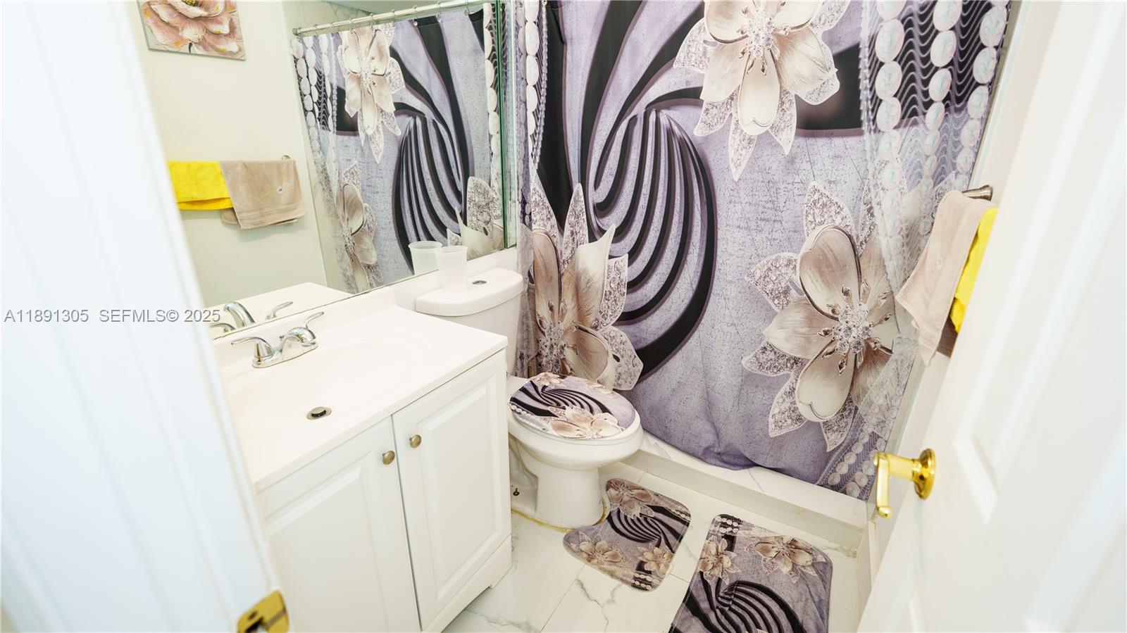 22226 Southwest 98th Place Cutler Bay, FL 33190 - Photo 23 of 29 a bathroom with a sink and a mirror