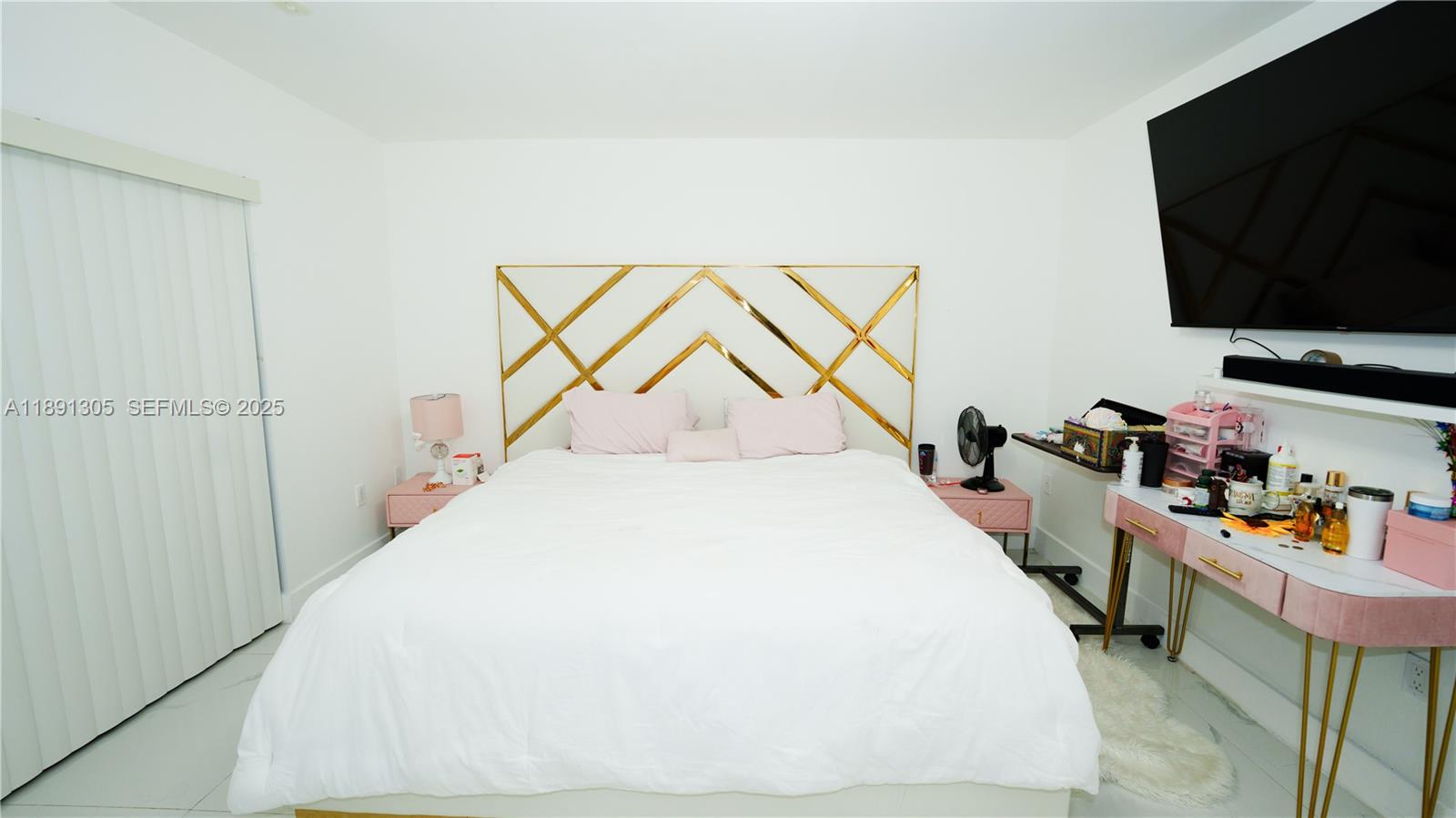 22226 Southwest 98th Place Cutler Bay, FL 33190 - Photo 24 of 29 a bedroom with a bed and a flat screen tv