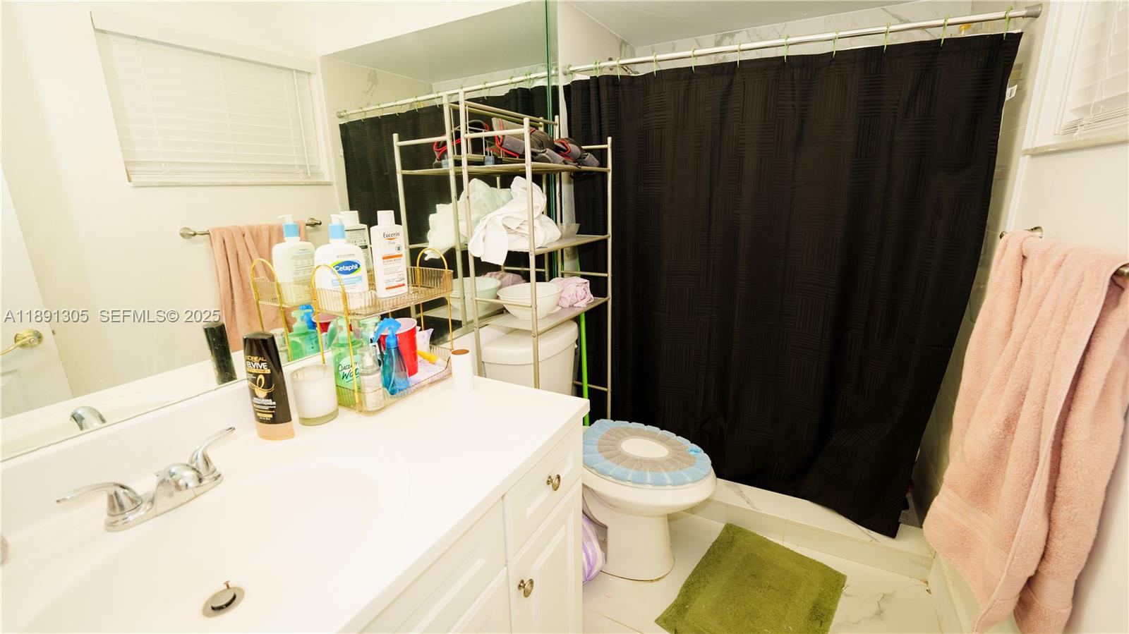 22226 Southwest 98th Place Cutler Bay, FL 33190 - Photo 25 of 29 a bathroom with a sink toilet and shower