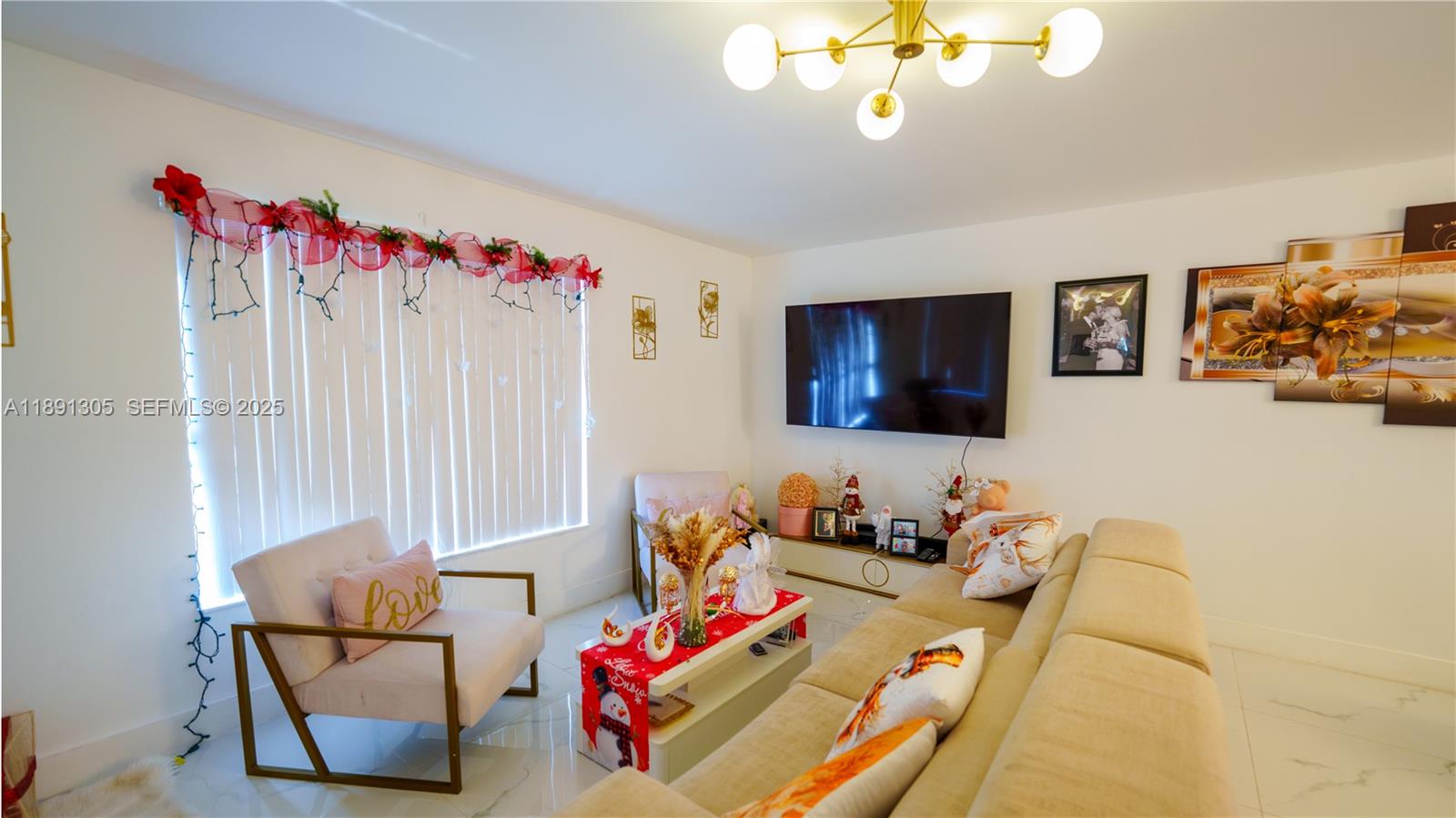 22226 Southwest 98th Place Cutler Bay, FL 33190 - Photo 9 of 29 a living room with furniture and a flat screen tv