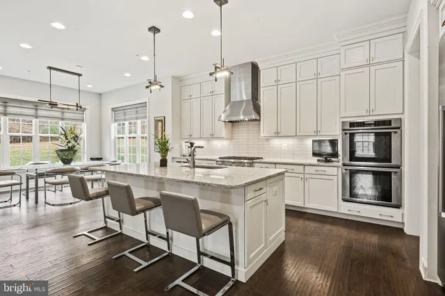 a living room with furniture rug and wooden floor