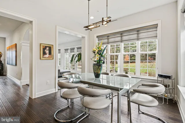 a view of a hallway with wooden floor windows and fireplace