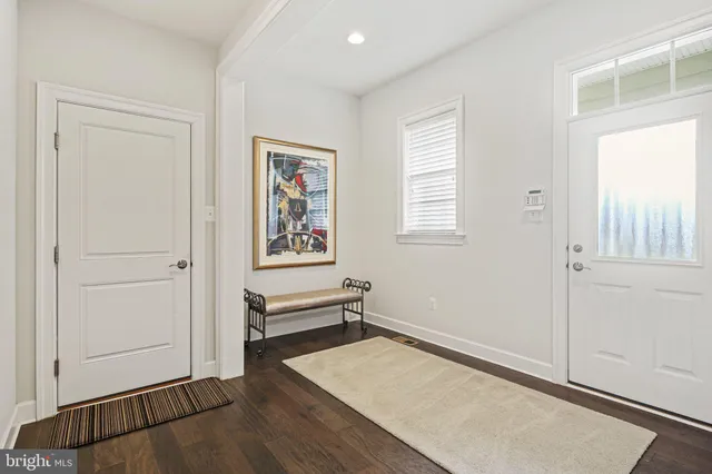 a spacious bathroom with a double vanity sink a mirror and a bathtub