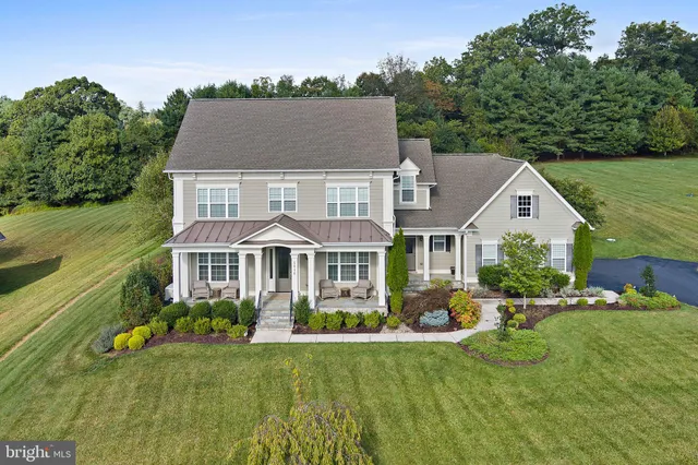 a front view of a house with a yard table and chairs