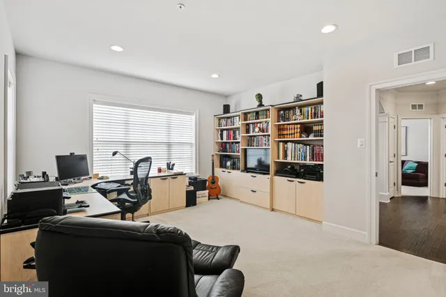 a view of a patio with couches and table and chairs and floor to ceiling window