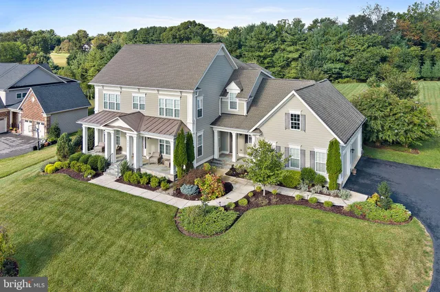 a aerial view of a house with a yard table and chairs