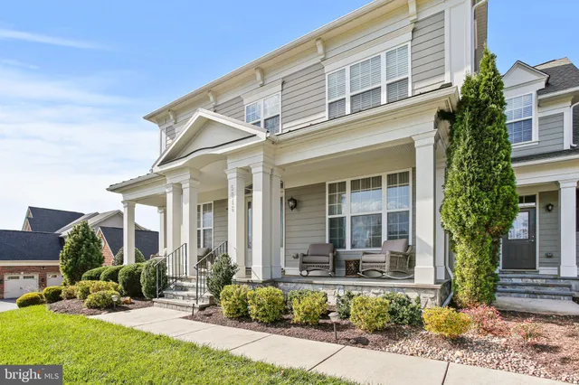 a view of a hallway with wooden floor windows and stairs