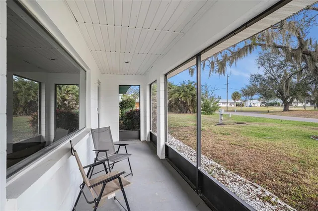 a view of a porch with furniture and garden