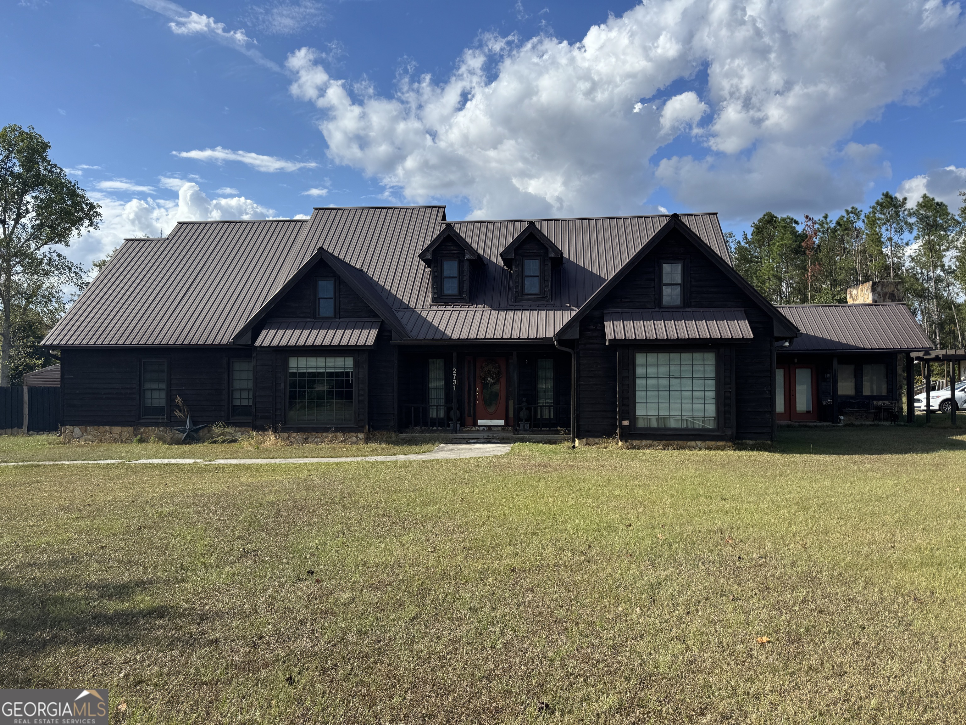 a front view of a house with a yard