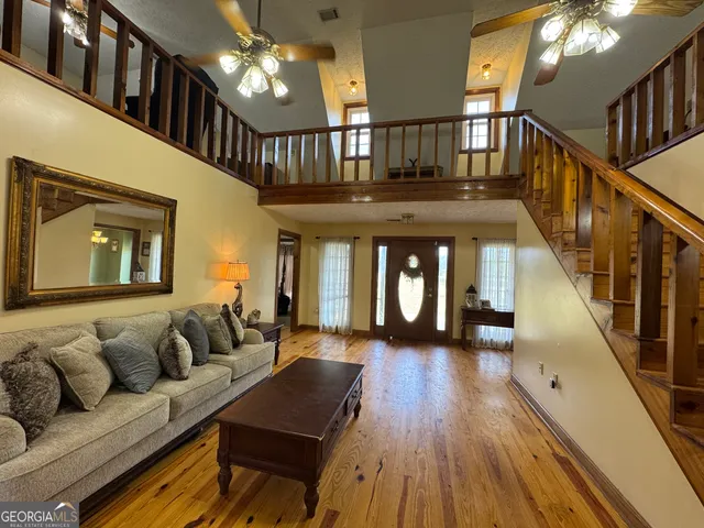 a living room with furniture and stairs