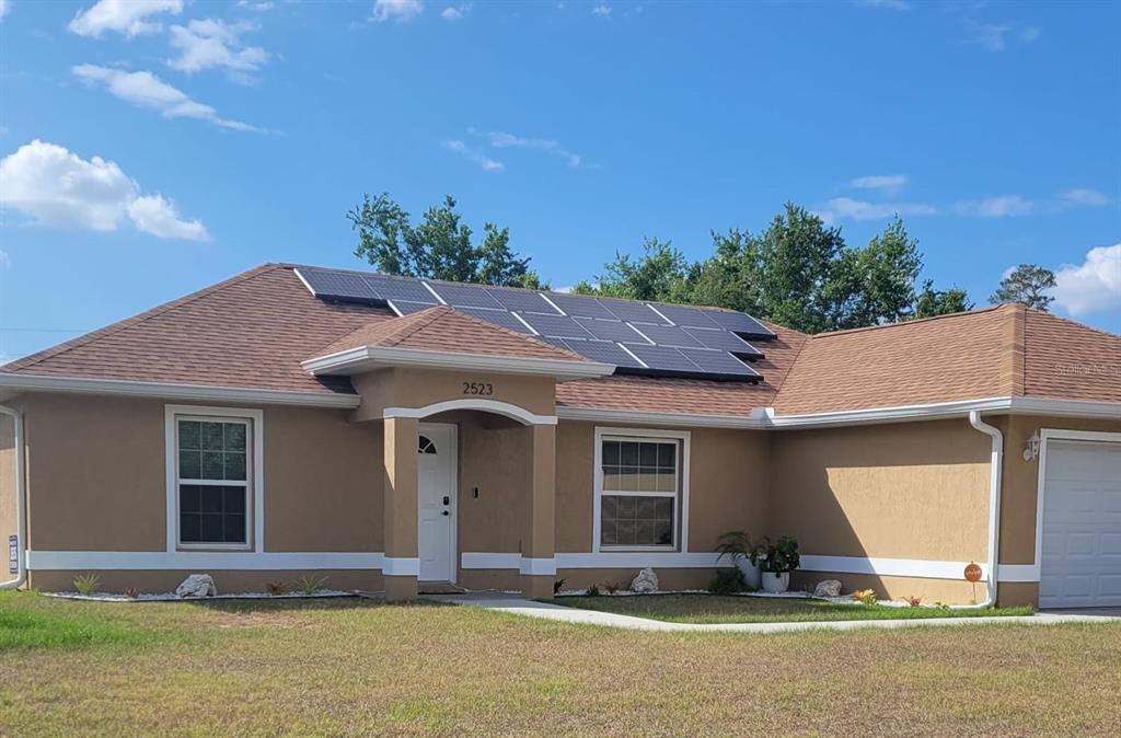 2523 Southwest 147 Place Road Ocala, FL 34473 - Photo 13 of 15 a front view of a house with a yard