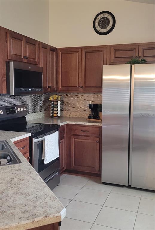 2523 Southwest 147 Place Road Ocala, FL 34473 - Photo 4 of 15 a kitchen with stainless steel appliances granite countertop a stove a microwave and a refrigerator