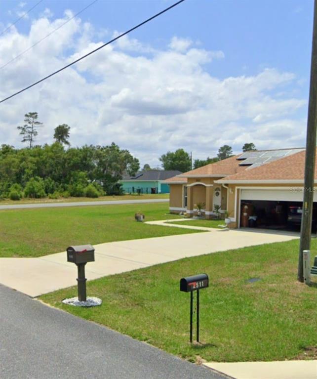 2523 Southwest 147 Place Road Ocala, FL 34473 - Photo 10 of 15 a front view of a house with garden