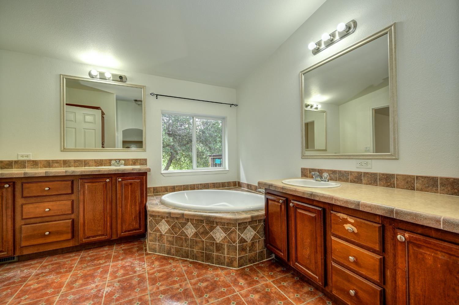 3680 Greenwood Road Garden Valley, CA 95633 - Photo 12 of 32 a bathroom with a granite countertop sink and a mirror