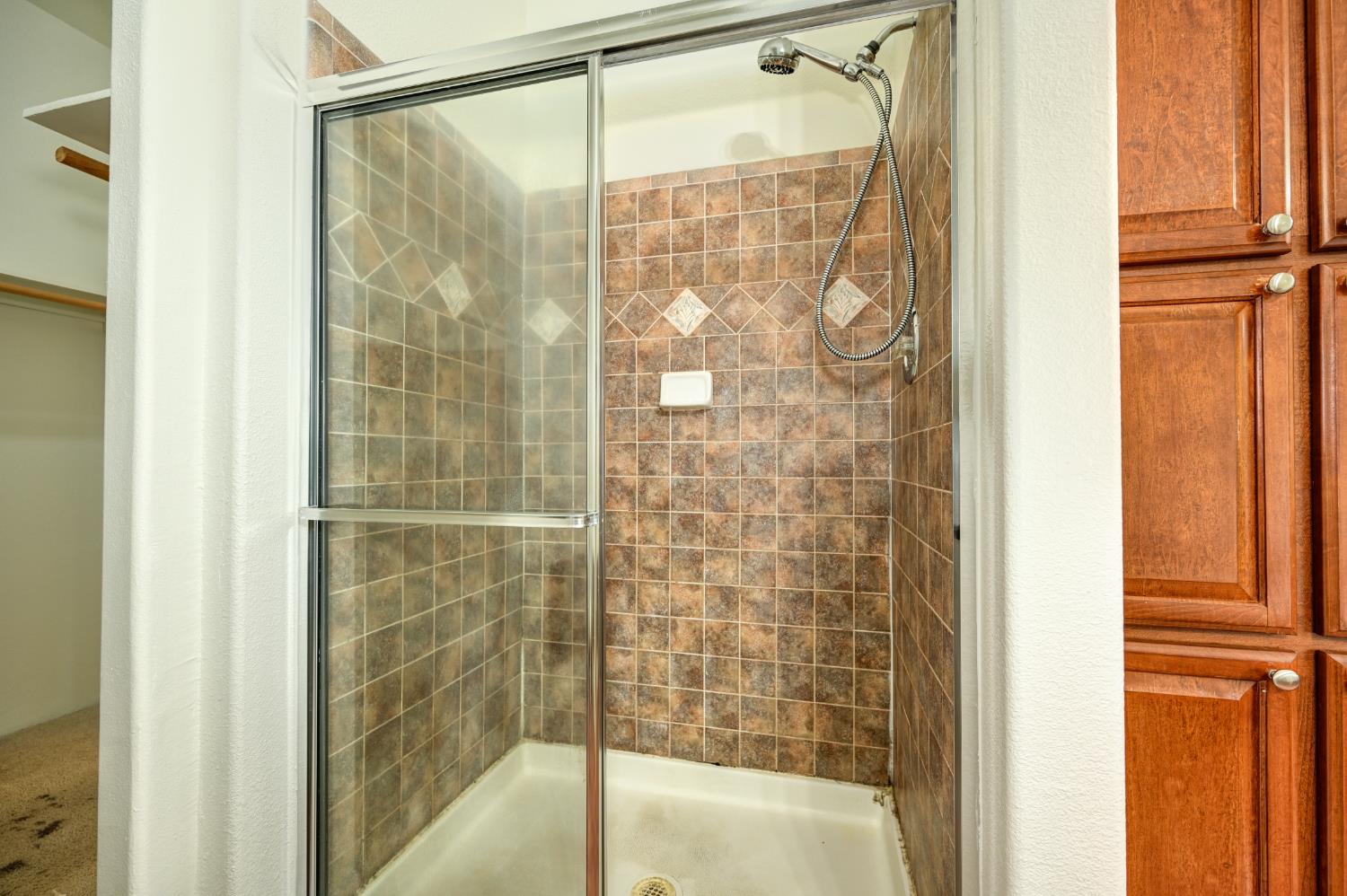 3680 Greenwood Road Garden Valley, CA 95633 - Photo 14 of 32 a bathroom with a glass shower door