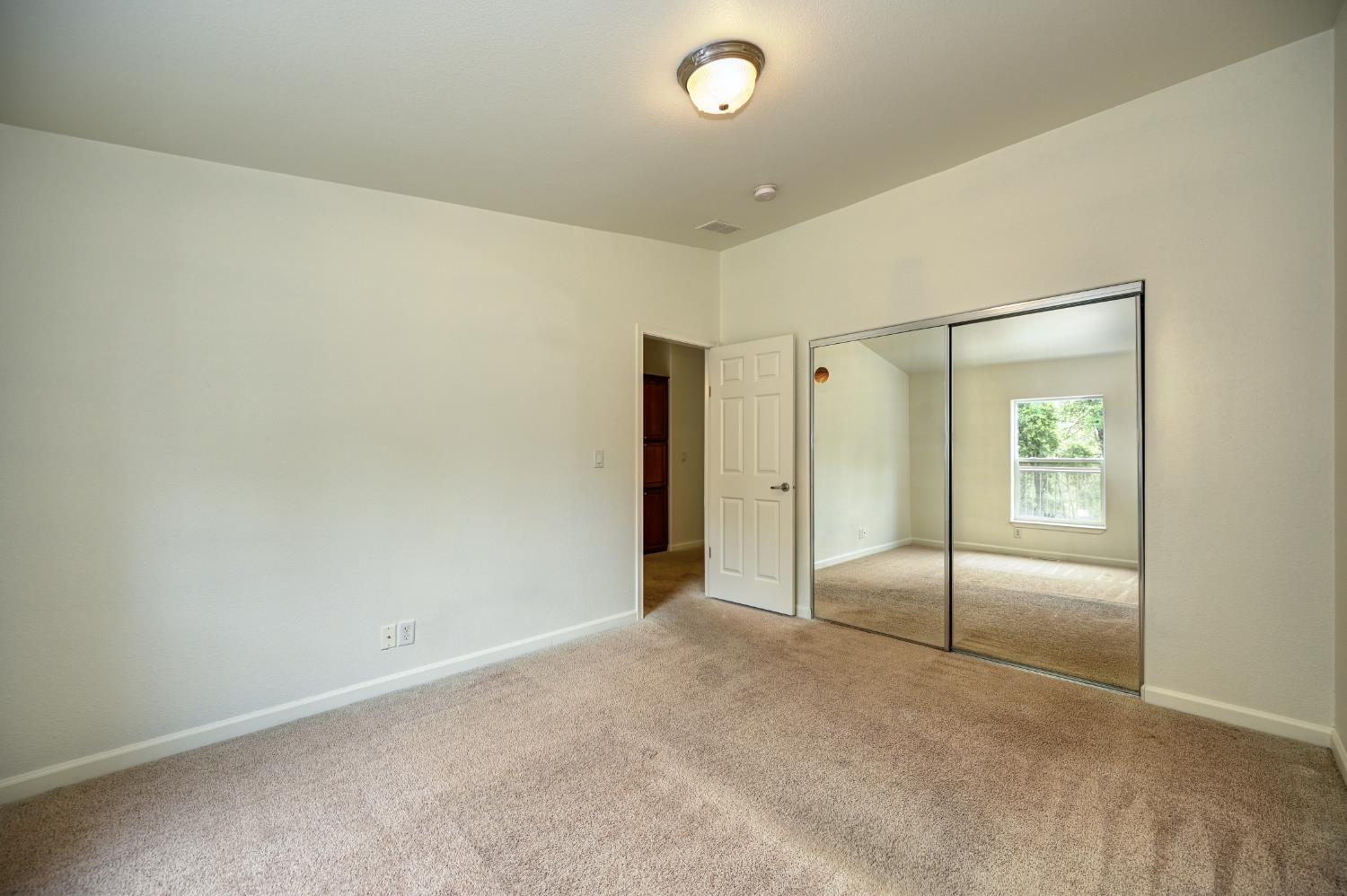 3680 Greenwood Road Garden Valley, CA 95633 - Photo 17 of 32 an empty room with sliding glass door