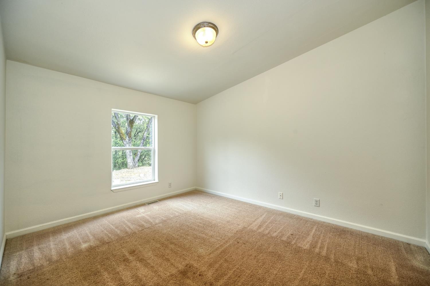 3680 Greenwood Road Garden Valley, CA 95633 - Photo 18 of 32 an empty room with a window