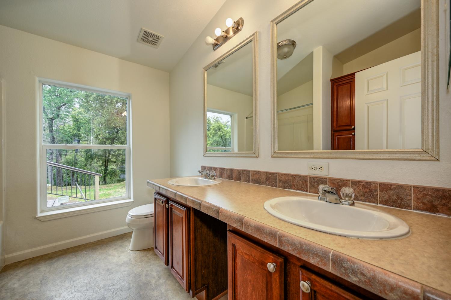3680 Greenwood Road Garden Valley, CA 95633 - Photo 19 of 32 a bathroom with a granite countertop sink and a mirror