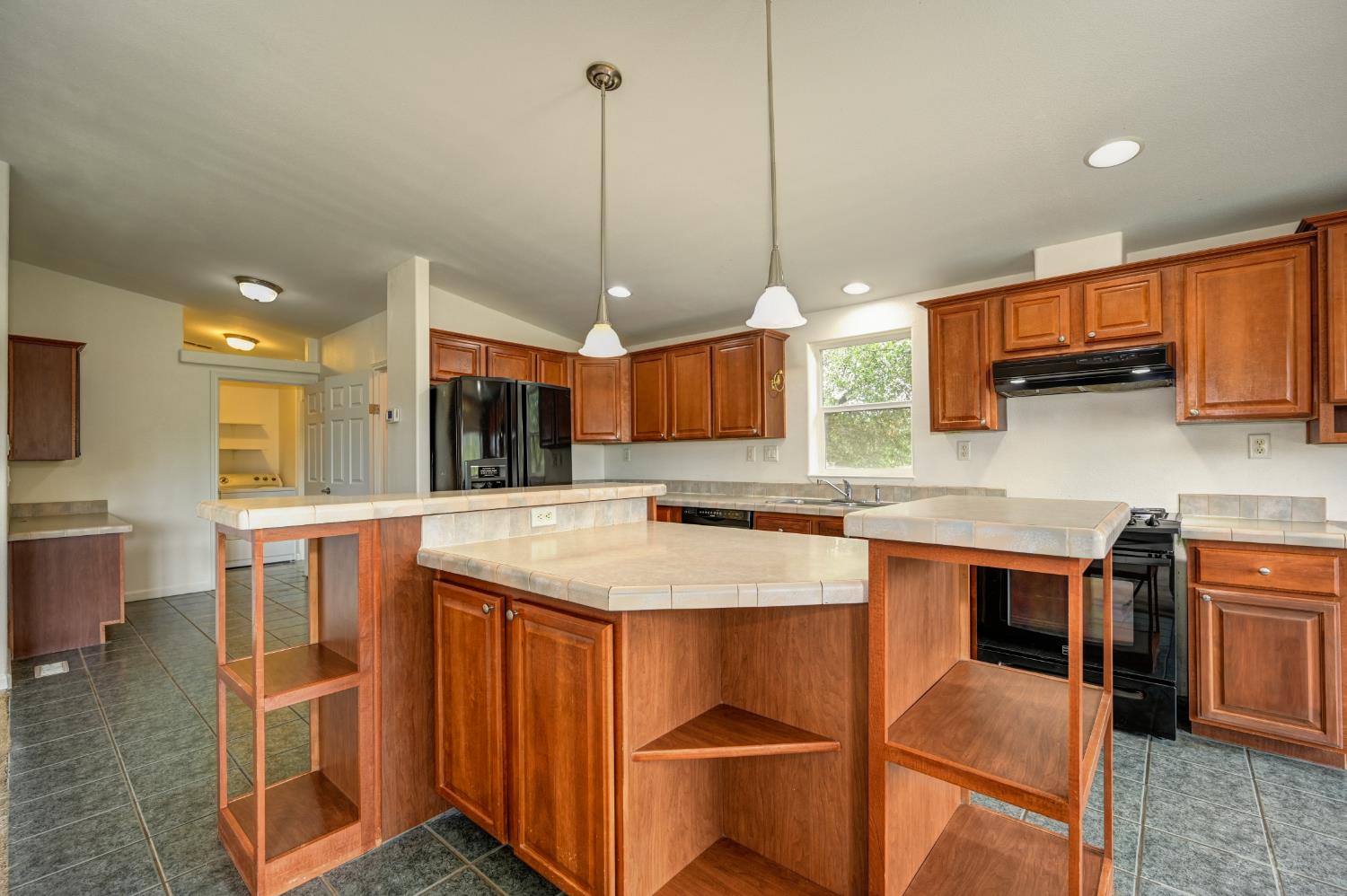3680 Greenwood Road Garden Valley, CA 95633 - Photo 3 of 32 a kitchen with stainless steel appliances granite countertop a sink a stove and a wooden floor