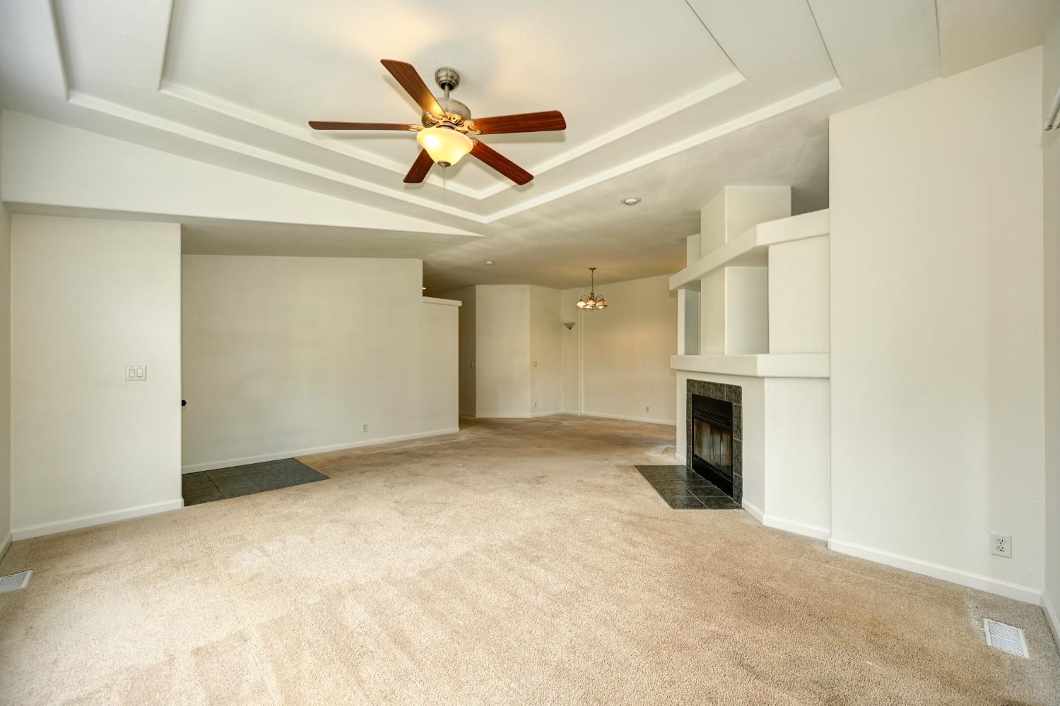 3680 Greenwood Road Garden Valley, CA 95633 - Photo 9 of 32 a view of a livingroom with a fireplace and a ceiling fan