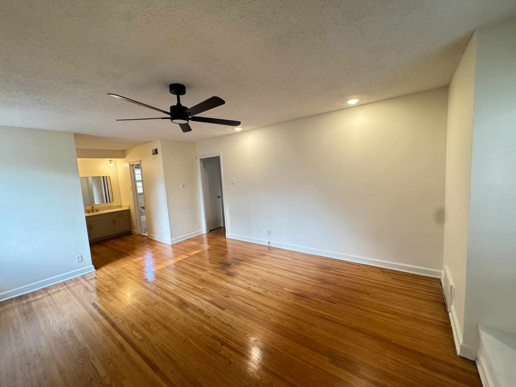 1345 Hickory Ridge Cove Memphis, TN 38116 - Photo 20 of 29 a view of a livingroom with wooden floor and a ceiling fan