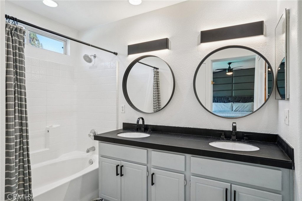 83290 Mango Walk Indio, CA 92201 - Photo 11 of 31 a bathroom with a double vanity sink and mirror
