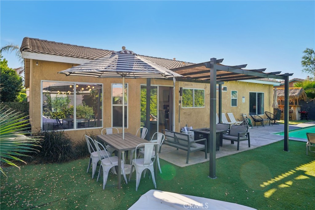 83290 Mango Walk Indio, CA 92201 - Photo 15 of 31 a view of a house with a dining table and chairs