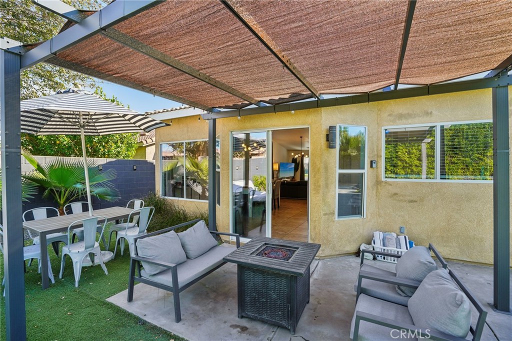 83290 Mango Walk Indio, CA 92201 - Photo 16 of 31 a outdoor living space with furniture and garden view