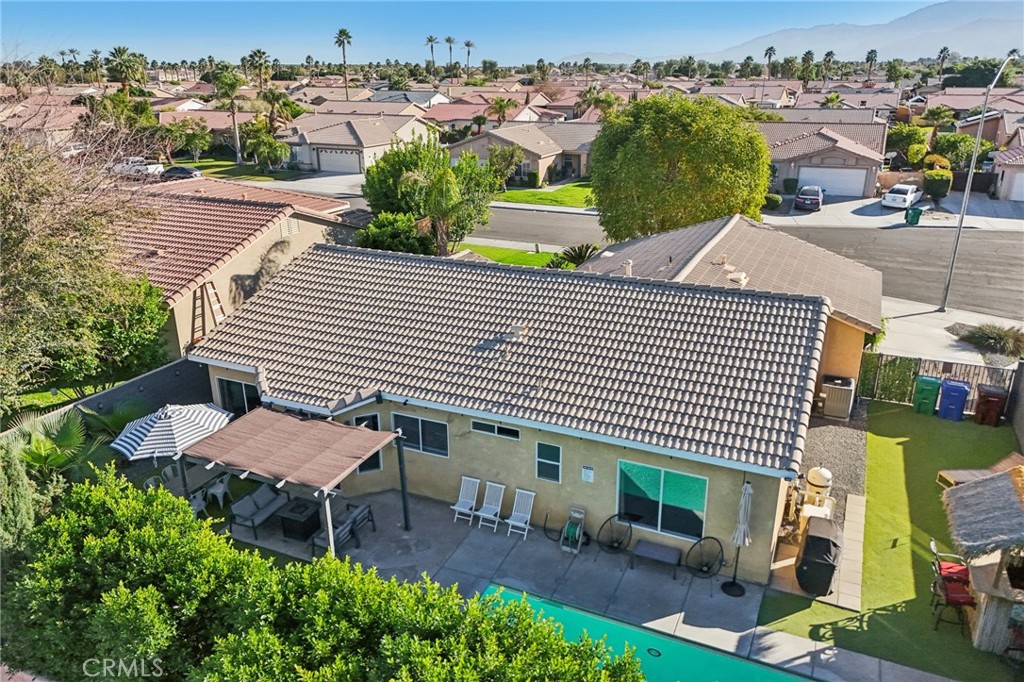 83290 Mango Walk Indio, CA 92201 - Photo 24 of 31 a view of a patio with a table and chairs under an umbrella