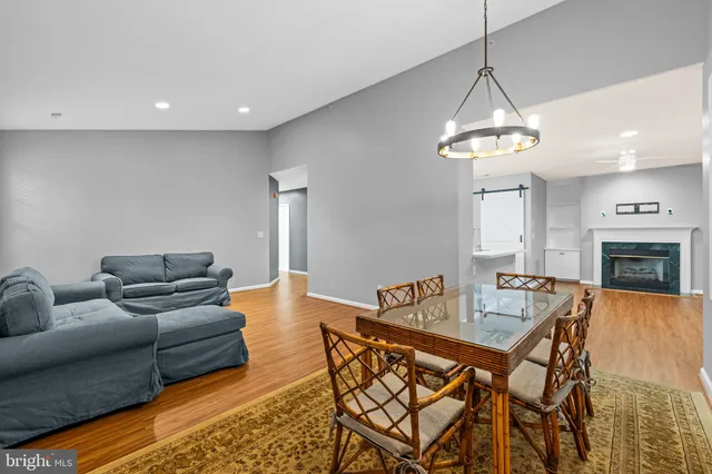 a living room with furniture a dining table and a chandelier