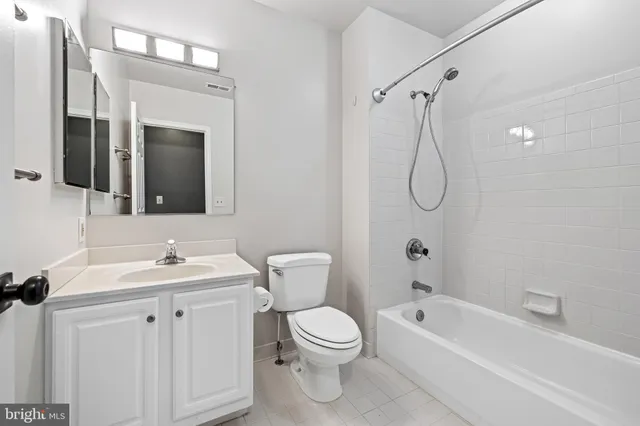 a bathroom with a toilet sink shower and mirror