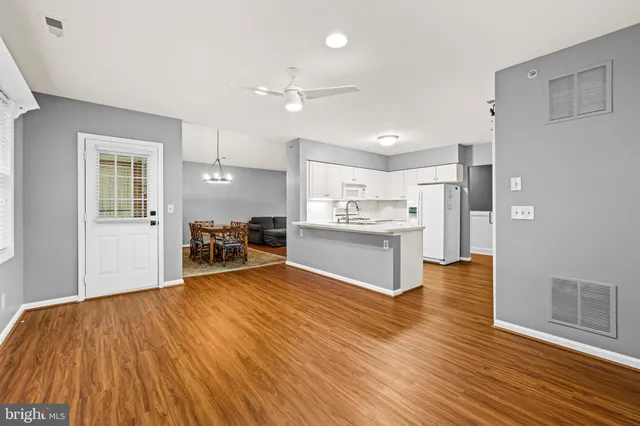 a view of kitchen with wooden floor and electronic appliances