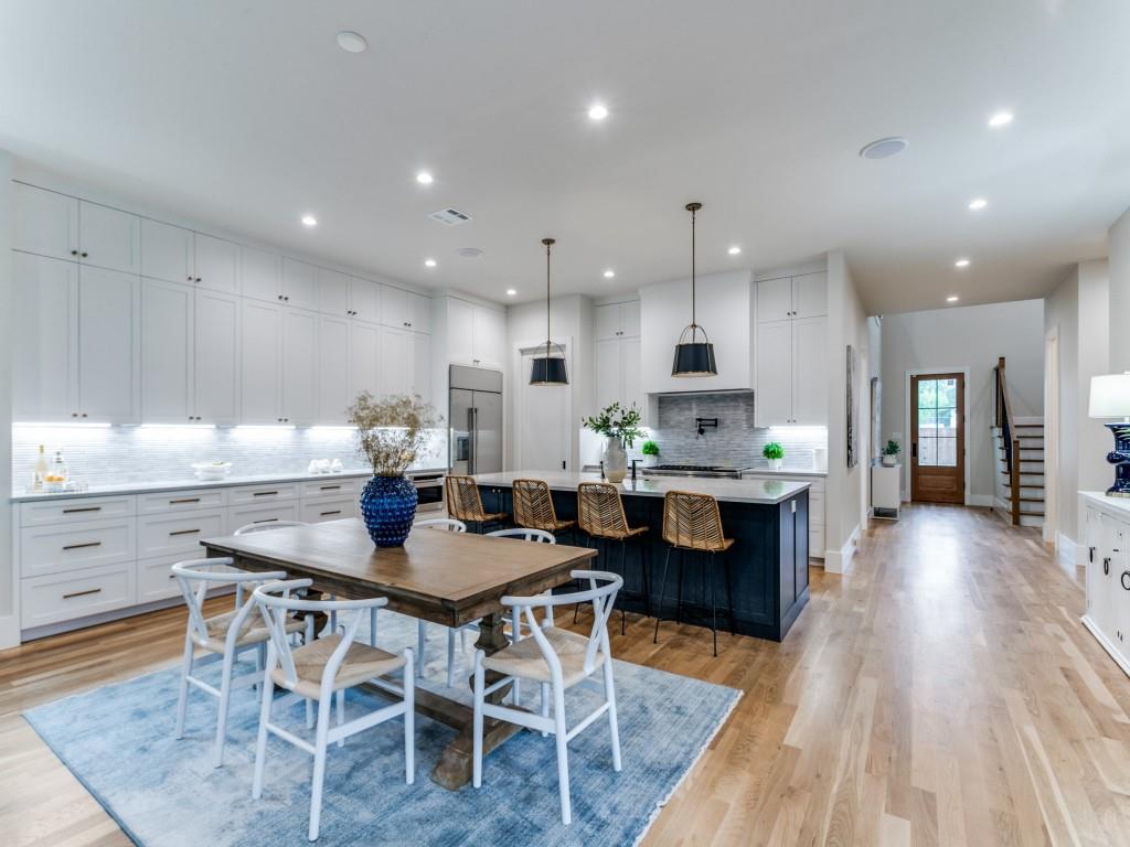3911 Hawick Lane Dallas, TX 75220 - Photo 11 of 23 a kitchen with stainless steel appliances kitchen island granite countertop a table chairs sink and cabinets