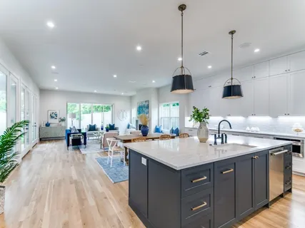 a kitchen with a sink stove and wooden floor