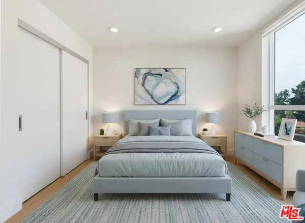 a bedroom with a large bed and a window