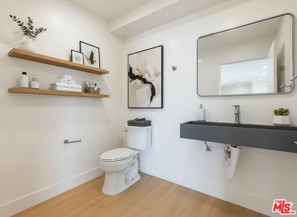 a bathroom with a toilet sink and mirror