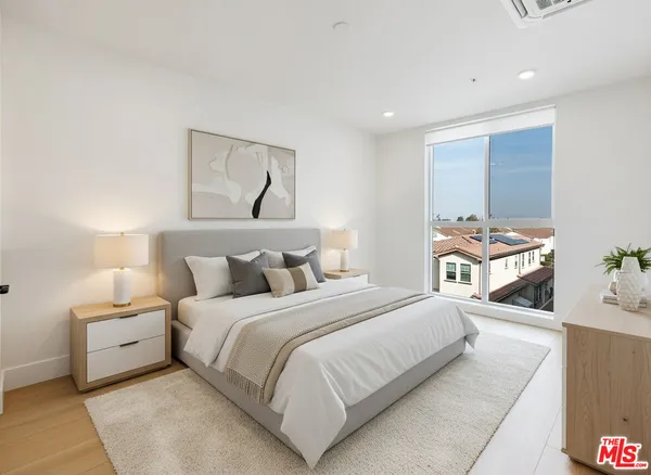 a bedroom with a bed and a painting on the wall