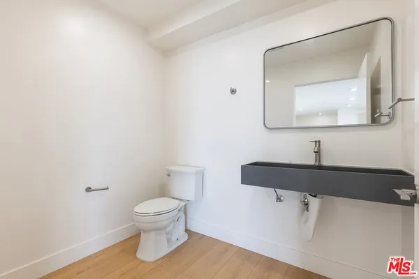 a bathroom with a toilet and a mirror