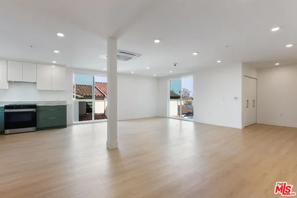 a view of kitchen with cabinets and wooden floor
