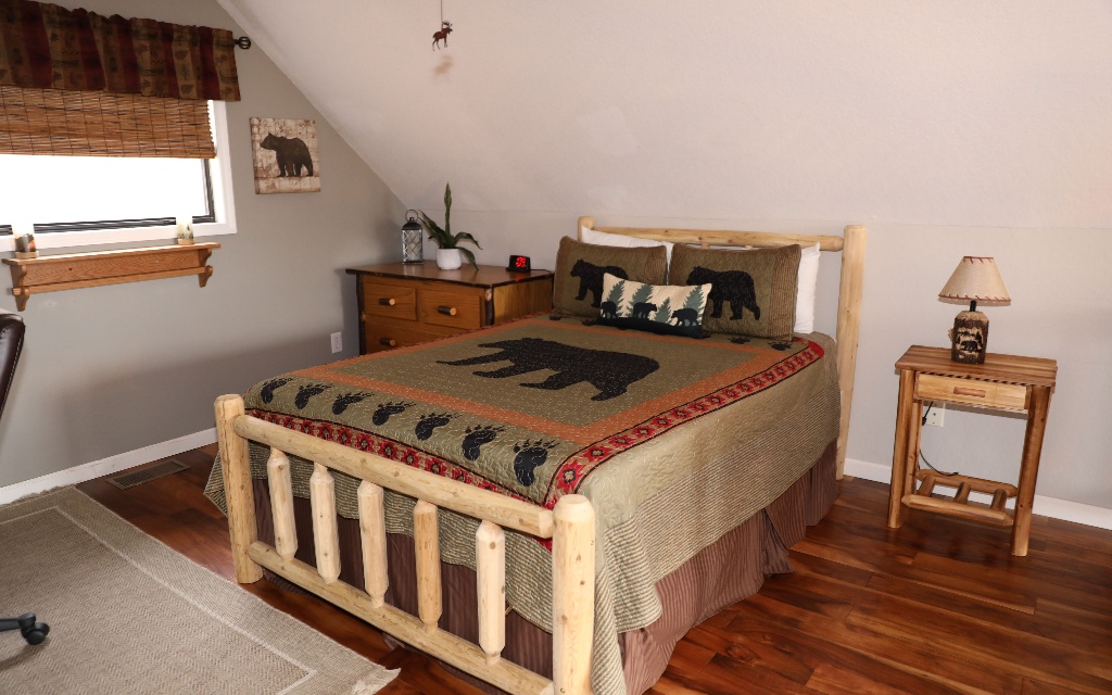 96 Indigo Ridge Murphy, NC 28906 - Photo 23 of 26 a bedroom with a bed and wooden floor
