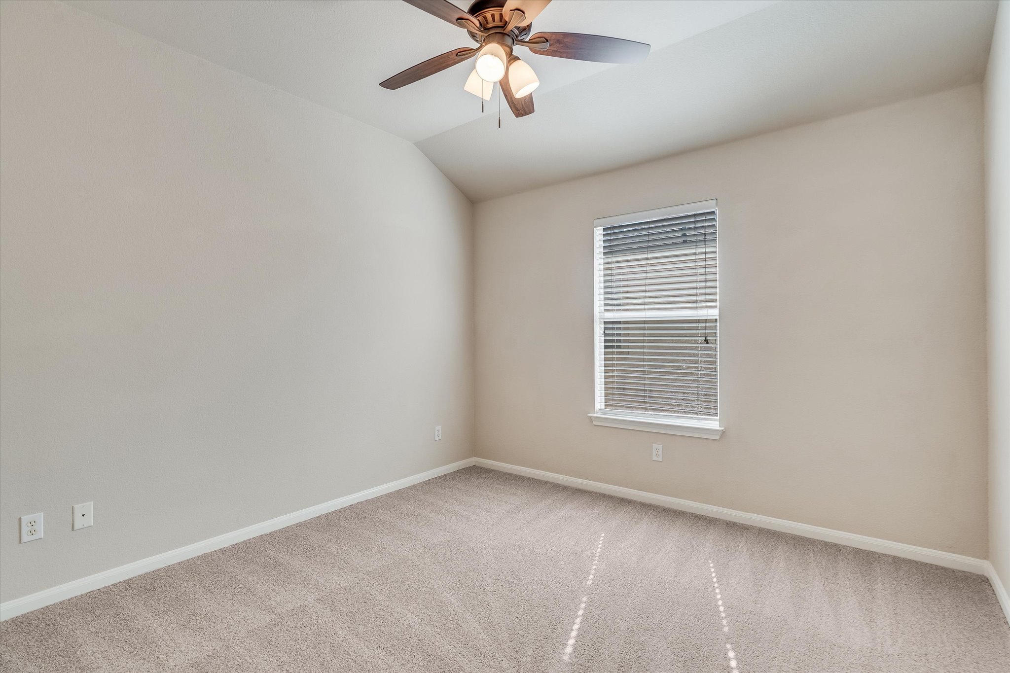 4029 Lake Edge Way Pflugerville, TX 78660 - Photo 18 of 35 Unfurnished room featuring light carpet, lofted ceiling, and ceiling fan